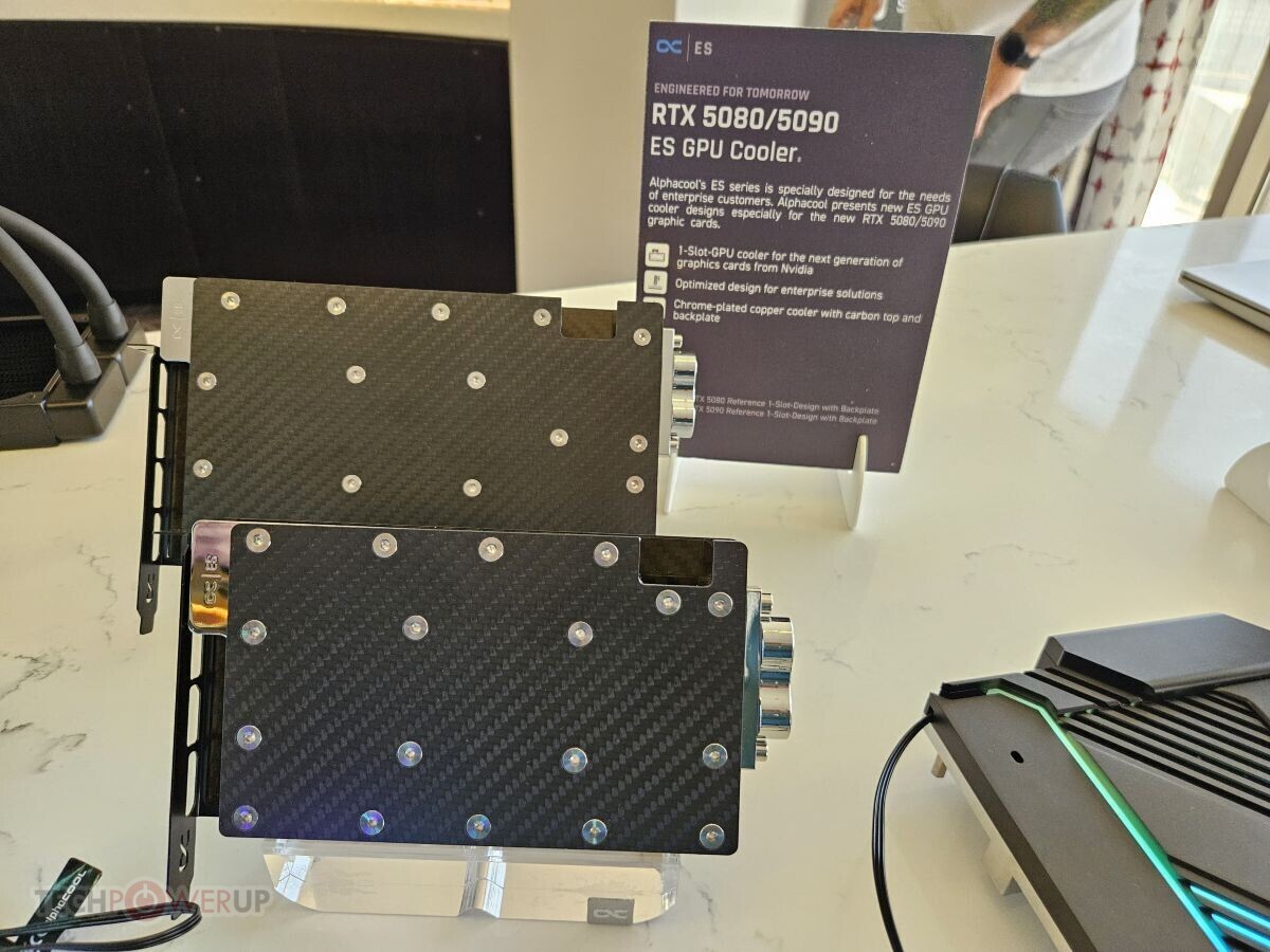Alphacool is displaying GPU waterblocks for NVIDIA GeForce RTX 5090/5080 and AMD X870 motherboard monoblocks.